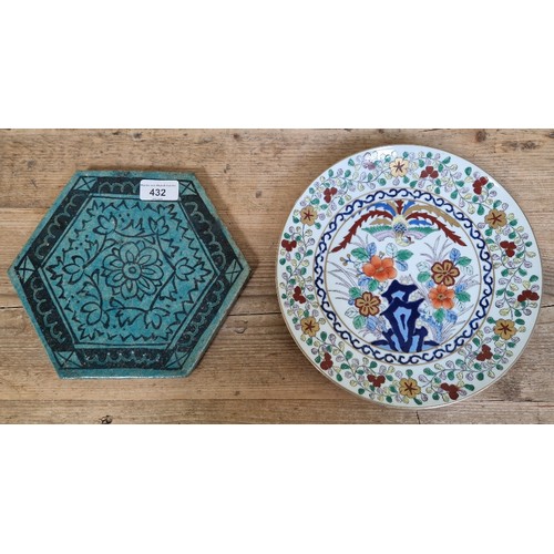 432 - A Persian tile of hexagonal form, length 23.5cm, together with a modern Chinese dish.