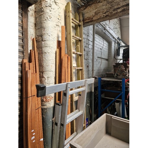 30 - A wooden extending ladder and an aluminium 3 way step ladder