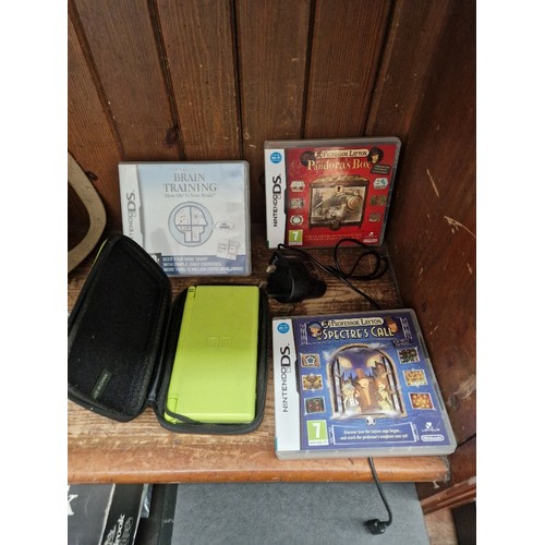 57 - A cased Nintendo DS together with games and power lead