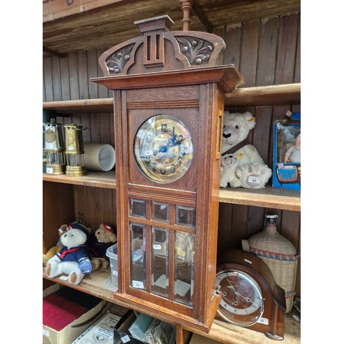 43 - An oak cased wall clock in working order