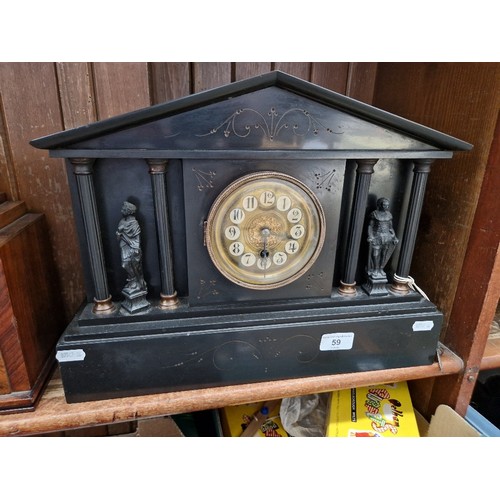 59 - A late 19th century black slate mantle clock, with key.