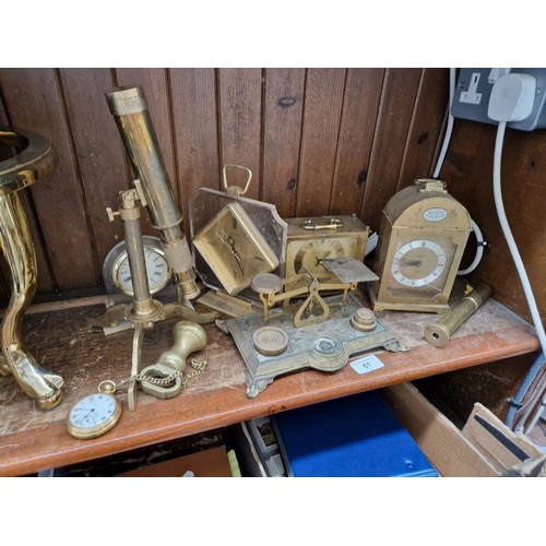 61 - A collection of brass items to include weighing scales with weights, telescopes and brass  faced clo... 