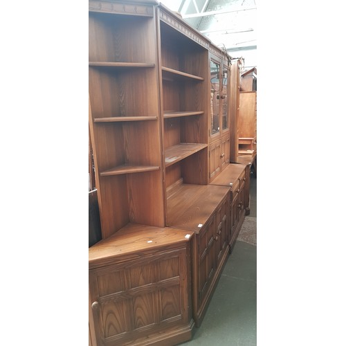 900 - An Ercol elm sectional lounge cabinet.