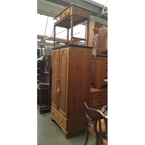 910 - A Ducal pine wardrobe and matching dressing table.