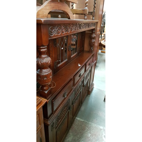 915 - A carved oak court cupboard.