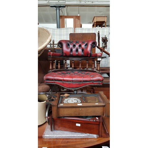 952 - An oxblood red leather Chesterfield captain's chair together with two wall clocks.