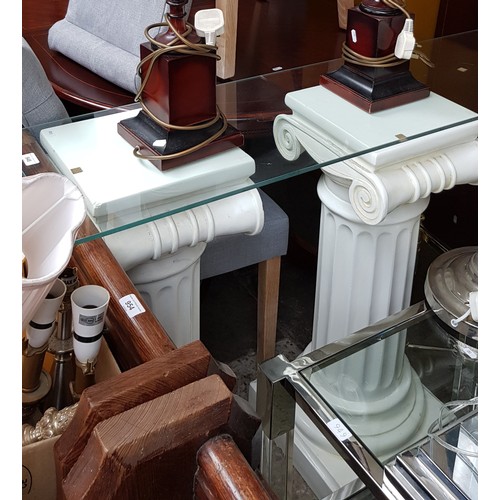 948 - A glass top side table on classical column style supports.