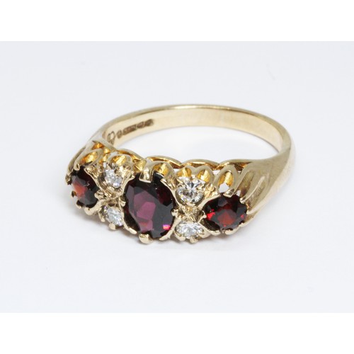 54 - A hallmarked 9ct gold garnet and diamond ring, sponsor 'FM' (Fred Manshaw Ltd), London 1967, gross w... 