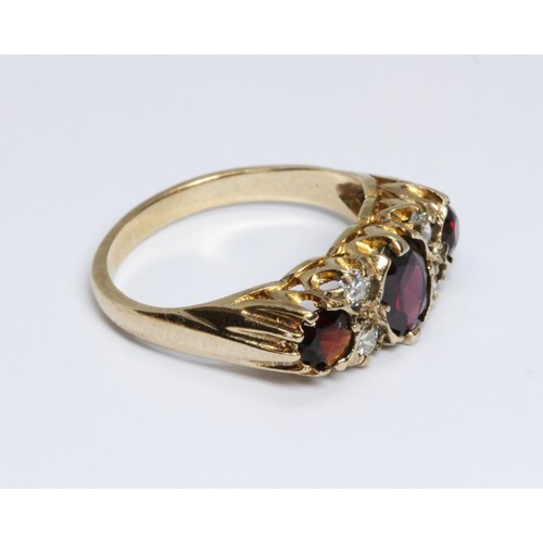 54 - A hallmarked 9ct gold garnet and diamond ring, sponsor 'FM' (Fred Manshaw Ltd), London 1967, gross w... 