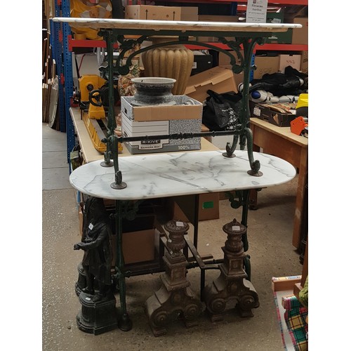 957 - A pair of marble and cast iron tables.