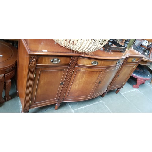 973 - A reproduction regency style bow front  mahogany sideboard by Charles Barr Furniture Ltd, length 180... 