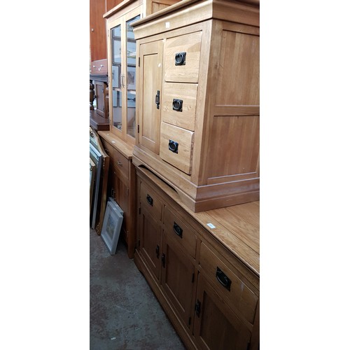 981 - Three pieces of modern light oak furniture; sideboard, side cabinet and a display cabinet.