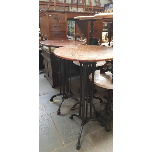 991 - A pair of cast iron and granite top bar tables, height 110cm & diameter 65cm.