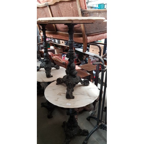 993 - A pair of cast iron and marble top tables, height 72cm & diameter 61cm.