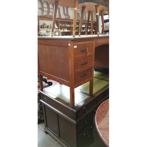 1010 - Two oak desks, one with tooled leather writing surface.