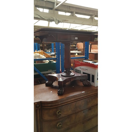 1015 - A 19th century mahogany fold top tea table, on reeded pedestal base with paw feet.