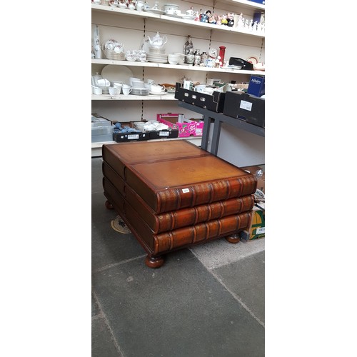 1013 - A mahogany and leather top coffee table modelled as a stack of books, the spines opening as drawers ... 