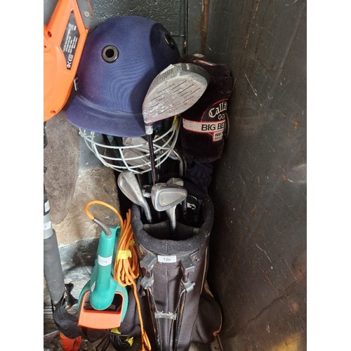 128 - Golf bag and clubs, a bundle of clubs and a cricket safety helmet