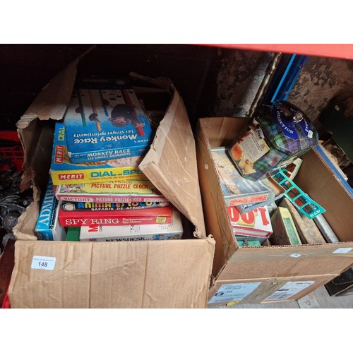 148 - 2 boxes of vintage jigsaws and boxed games etc