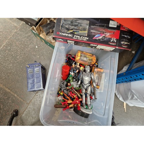 178 - A box of action figures, remote controlled helicopter etc