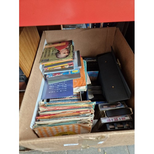 203 - A box of CDs, vinyl singles, cassettes, 8 track stereo cartridges together with 2 boxes of books