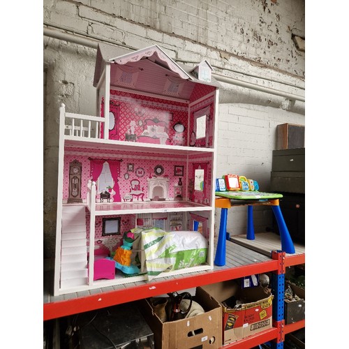 220 - An open fronted 3 storey dolls house and a bag of accessories and a child's educational desk