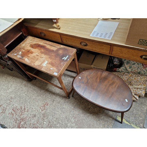 1023 - An Ercol dark elm pebble table & a McIntosh swivel top teak trolley.