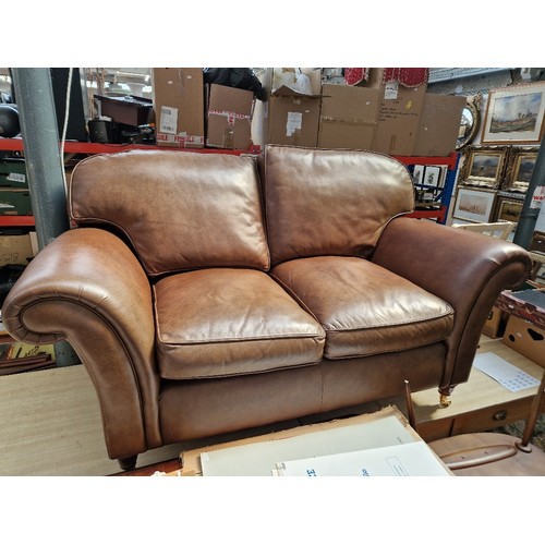 1022 - A brown leather Laura Ashley 2 seater sofa.