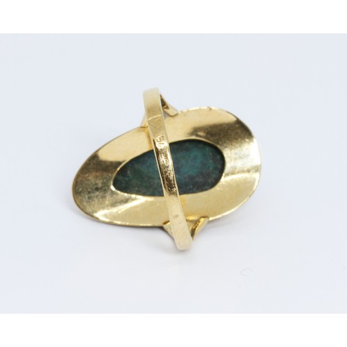 66 - A foreign yellow metal ring set with a green cabochon, indistinctly marked, gross weight 3.6g, size ... 