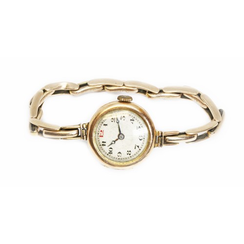 77 - A ladies early 20th century hallmarked 9ct gold wristwatch with strap marked '9ct', gross weight 18.... 