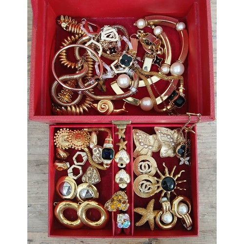 166 - A red box containing gold plated costume jewellery, various makes including Monet, Napier, Butler an... 