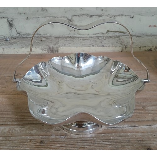 191 - A hallmarked silver footed bowl with swing handle, height 18cm, weight 19.6ozt.