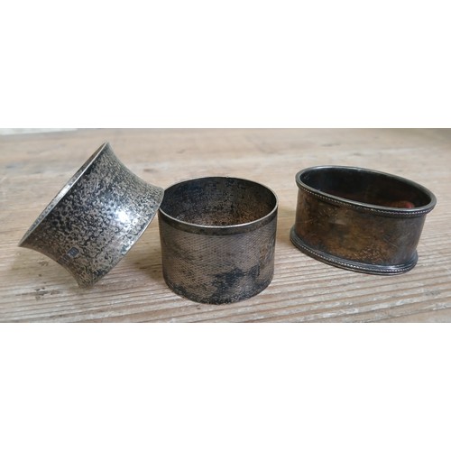 193 - Two hallmarked silver napkin rings, weight 2.5ozt, together with a silver plated napkin ring.