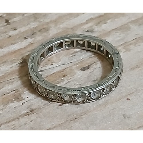 240 - An antique early 20th century colourless stone white metal eternity band, marked '9ct', gross weight... 