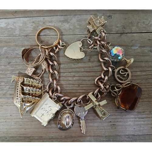 230 - A charm bracelet, various charms comprising a 22ct gold ring, weight 3g, seven hallmarked 9ct gold c... 