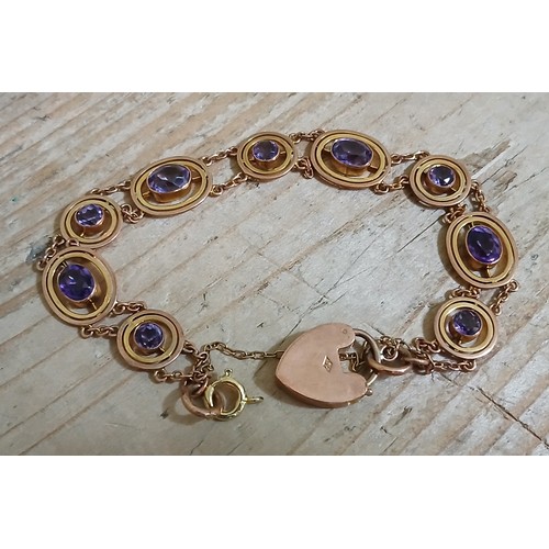 259 - An antique amethyst bracelet, the heart shaped padlock clasp marked '9c', length 18cm, gross weight ... 