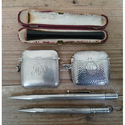 214 - A mixed lot comprising two hallmarked silver vesta cases, two pencils marked 'Sterling Silver' and a... 