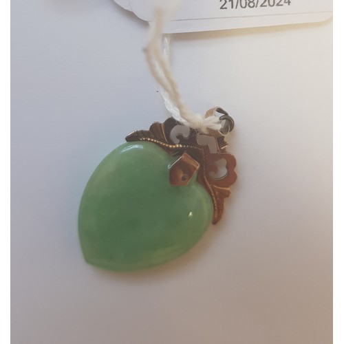 74 - A jadeite jade heart shaped double sided cabochon pendant, yellow metal mount, the bail marked '585'... 