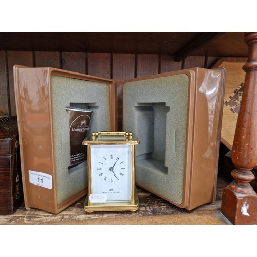 11 - A Mathew Norman brass carriage clock with case and papers.