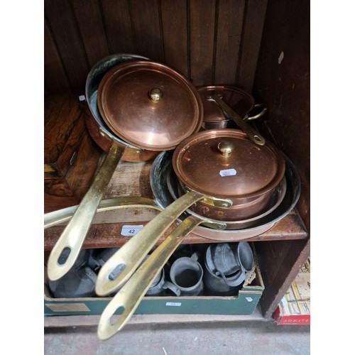 42 - A set of three copper pans with brass handles and 2 similar frying pans