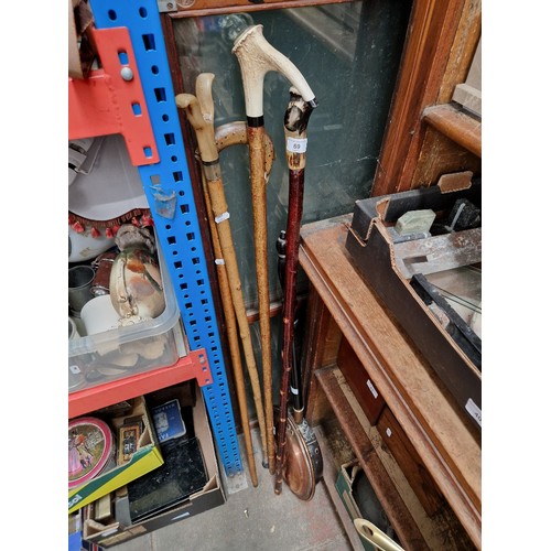 69 - 4 walking staffs with ornamental heads