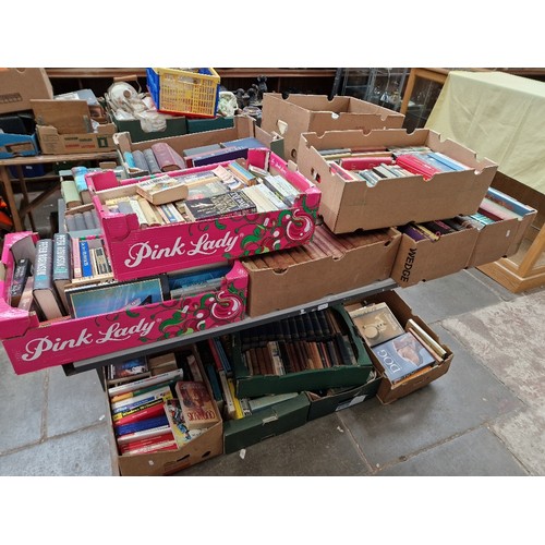 114 - 16 boxes of books on table top and one side below