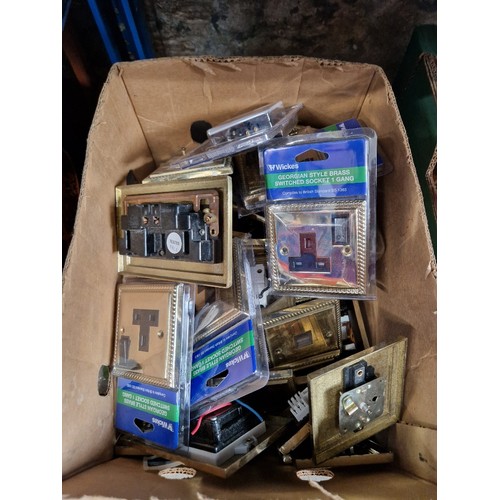 92 - A box of brass faced electrical sockets, used and unused