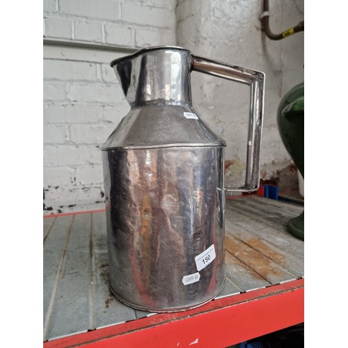 150 - A Metal milk can with an attached metal label stating 