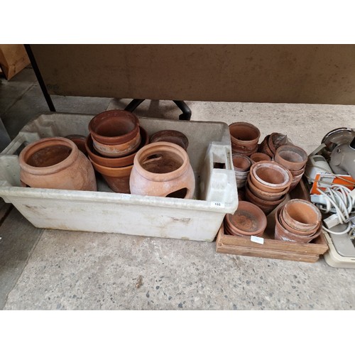 185 - 50 terracotta pots of various sizes including two strawberry planters, 4 saucers and bag of crocks.