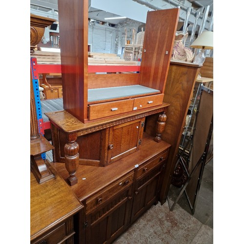 1001 - An oak court cupboard and a modern side table with glass shelf.