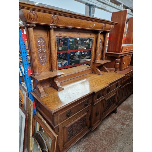 1000 - An Edwardian Arts & Crafts oak mirror back sideboard.