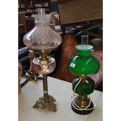 396 - Oil lamp with pink glass bowl and shade, together with another having green bowl and shade, and conv... 