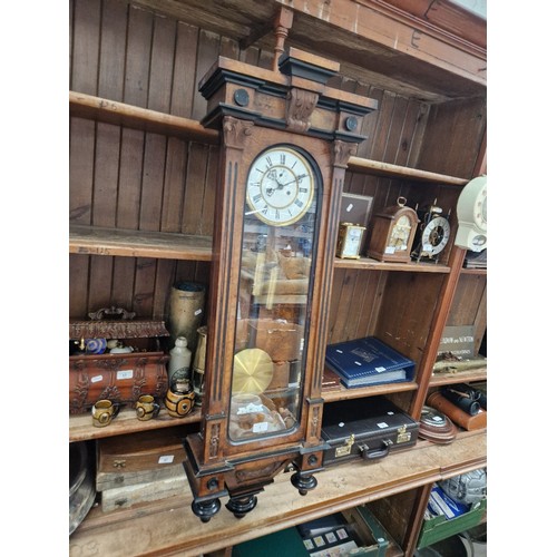 1 - A walnut and ebonised cased Vienna wall clock with weights and pendulum.