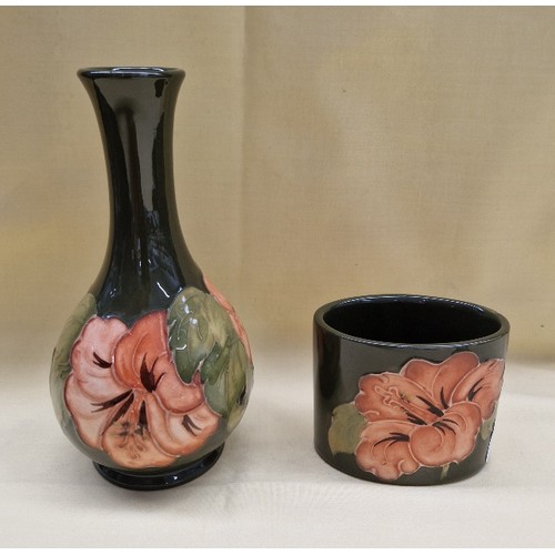 451 - Two pieces of Moorcroft pottery, both coral hibiscus pattern on green ground. Bulbous bud vase with ... 